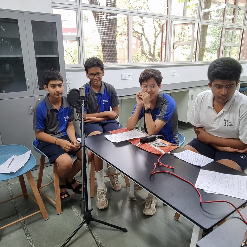 Kids in a podcast workshop