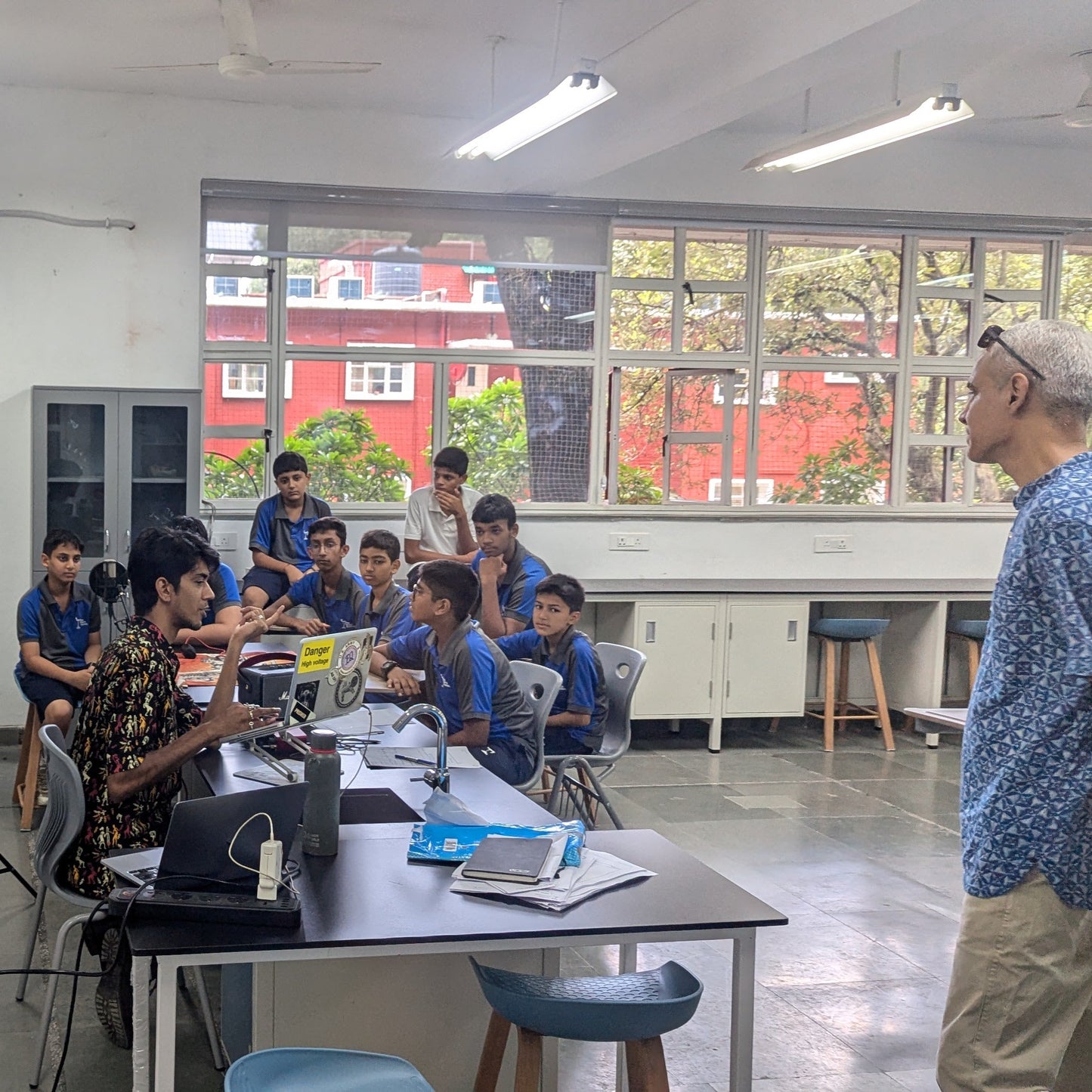 Classroom setting with students and a teacher in a modern educational environment.